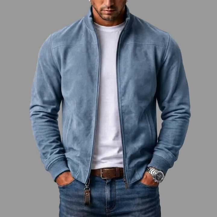 Model i lyseblå jakke i ruskindslook med åben lynlås, ribmanchetter og læderlap på lynlåsen, over hvid t-shirt. 4