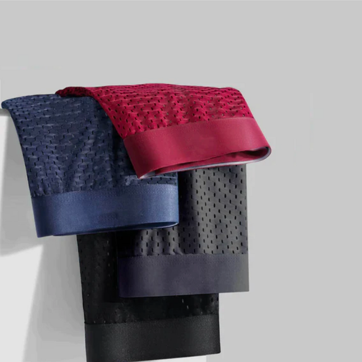 Fire boxershorts i rød, marineblå, sort og grå hængt over en kant, med net og brede linninger 3