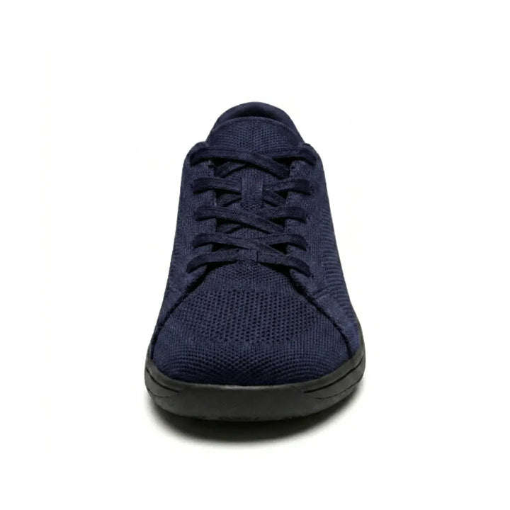 Marineblå mesh-sneaker med sort sål set direkte forfra, så den brede tåboks og snørringen vises. 26
