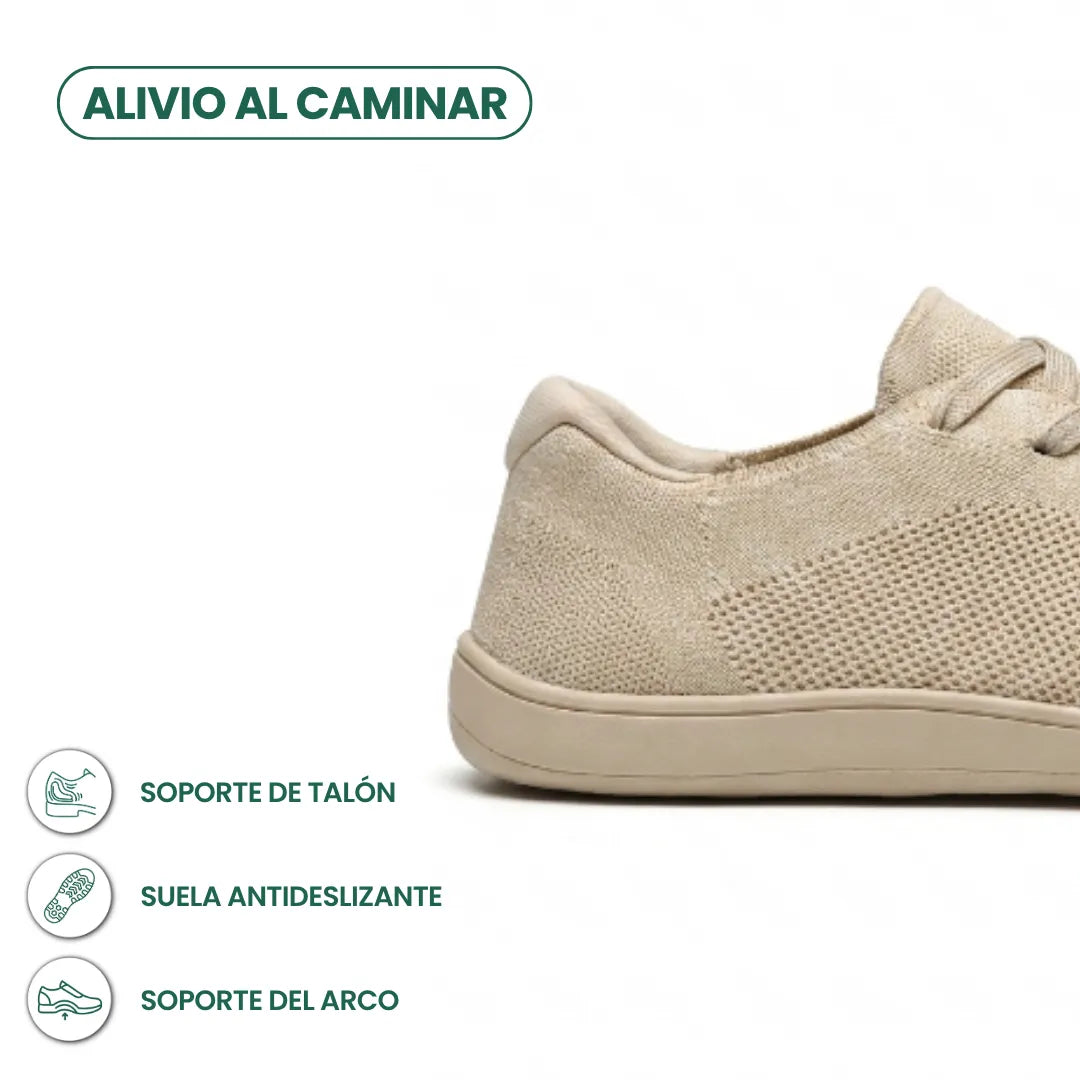Beige sneakers set bagfra og fra siden med ikoner for hælstøtte, skridsikker sål og fodbuestøtte. 4