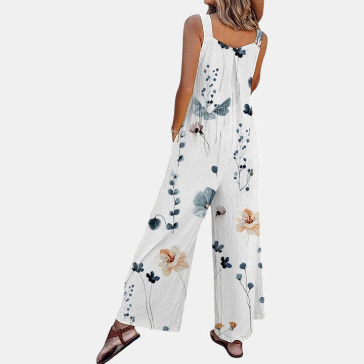Hvid overall med blomsterprint set bagfra og lidt fra siden, med vide ben 5