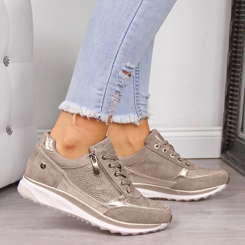 Sandfarvede sneakers med metalliske detaljer og sidelynlås båret af model i hullede jeans 5