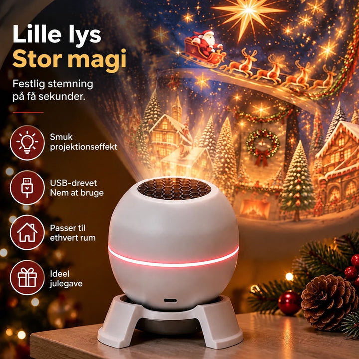 Nærbillede af den hvide projektor med lysende rød ring, der projicerer julemotiv, omgivet af grankogler og julepynt 3