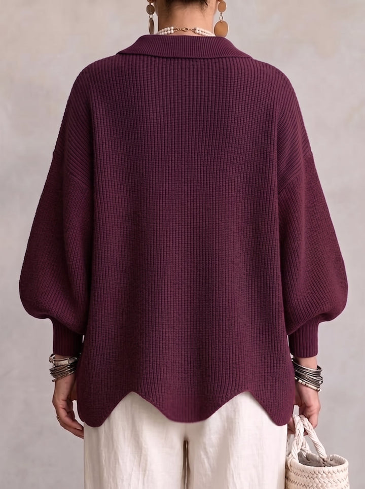 Model set bagfra i blommefarvet ribstrikket cardigan med spids krave, brede ærmer og bølgekant forneden. 15