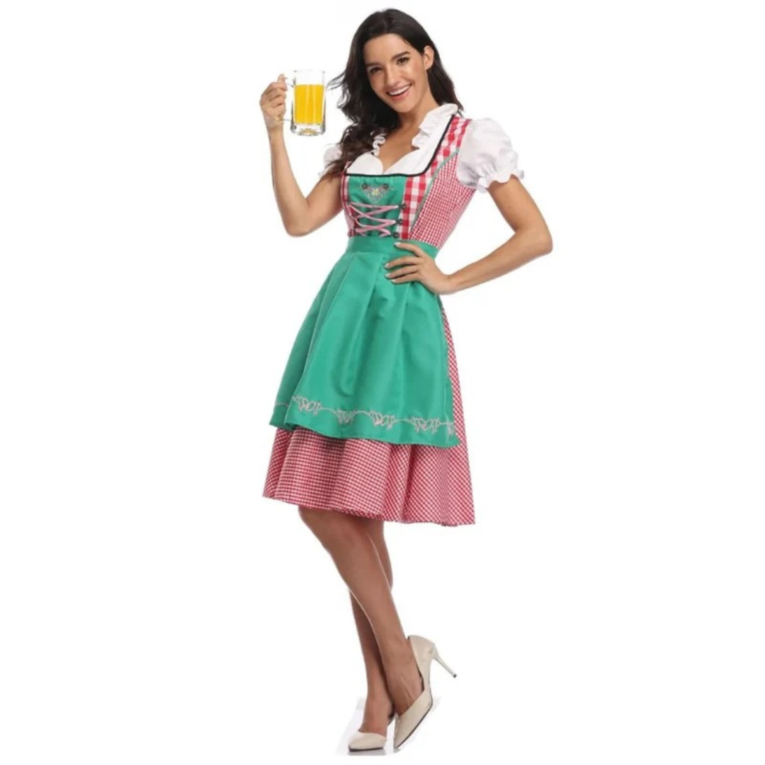 Model i dirndl med grønt forklæde over rødternet skørt, hånd i siden og et glas øl i den anden hånd. 4